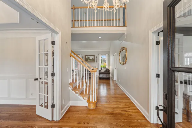a view of a hallway with wooden floor and entryway