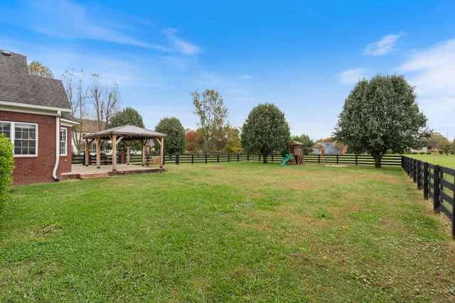 a front view of house with yard and green space