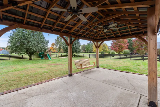 an aerial view of a house with a garden and lake view