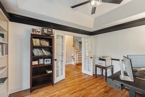 a living room with hard wood floors and a bed