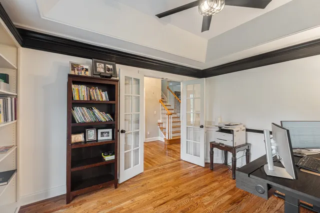 a living room with hard wood floors and a bed