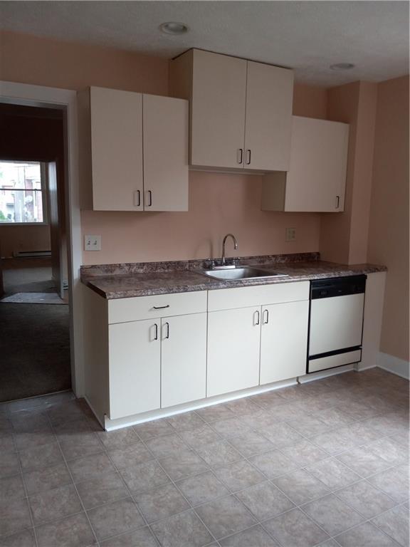 808 18th Street Ambridge, PA 15003 - Photo 13 of 49 a kitchen with granite countertop white cabinets and white appliances