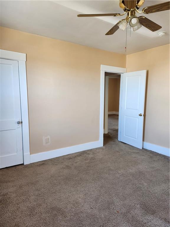 808 18th Street Ambridge, PA 15003 - Photo 21 of 49 an empty room with a ceiling fan and a window