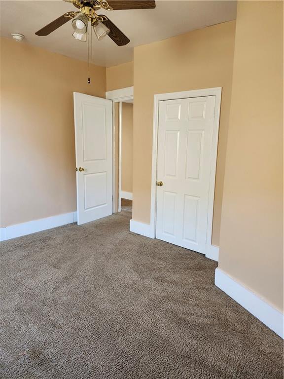 808 18th Street Ambridge, PA 15003 - Photo 22 of 49 an empty room with a ceiling fan and carpet