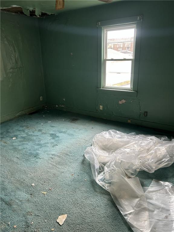 808 18th Street Ambridge, PA 15003 - Photo 46 of 49 a bed sitting in a bedroom next to a window