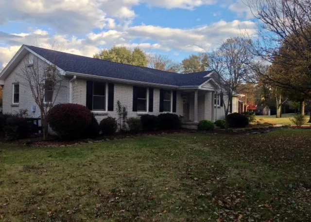 a view of a house with a backyard