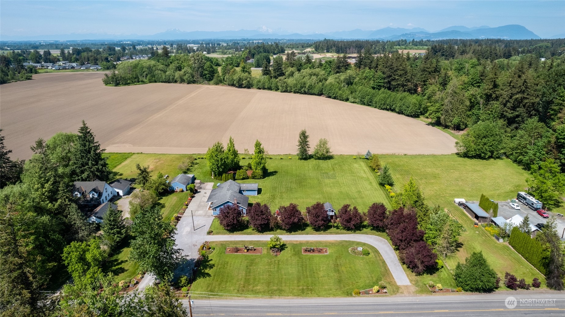 3304 South Pass Road Everson, WA 98247 - Photo 38 of 40 an aerial view of a house with a garden and lake view