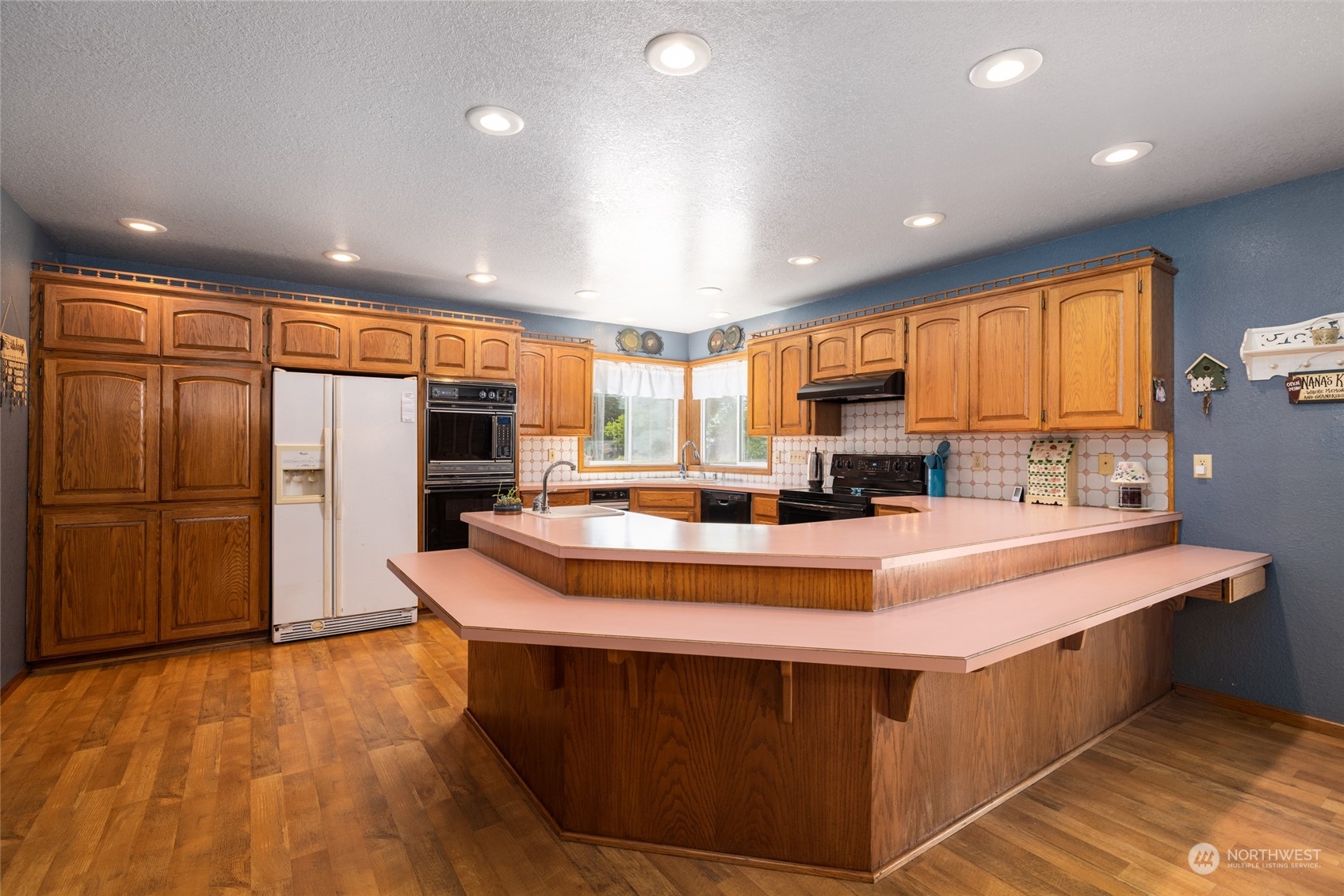 3304 South Pass Road Everson, WA 98247 - Photo 6 of 40 a large kitchen with stainless steel appliances a large counter top a stove a sink a refrigerator and cabinets