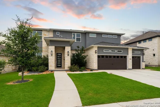 a front view of a house with a yard and garage