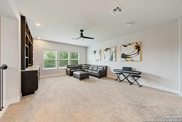 a view of a livingroom with furniture and a window