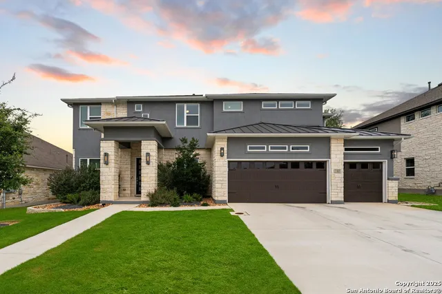 a front view of a house with a yard and garage