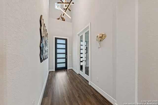 a view of a hallway with wooden floor and closet