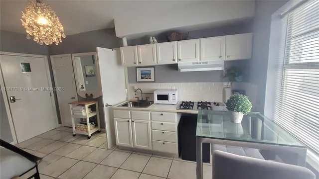 a kitchen with stainless steel appliances granite countertop a refrigerator sink and cabinets
