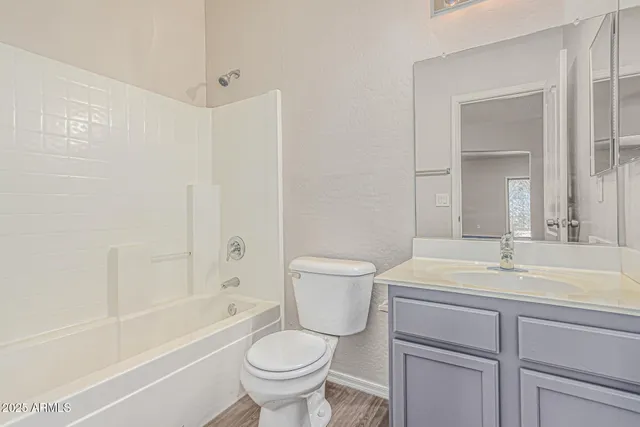 a kitchen with kitchen island a sink a stove a refrigerator and white cabinets