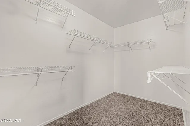 an empty room with a ceiling fan and a window