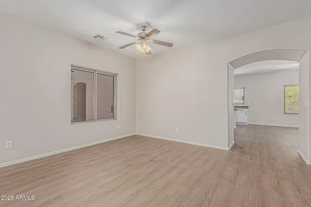 a view of an empty room with wooden floor