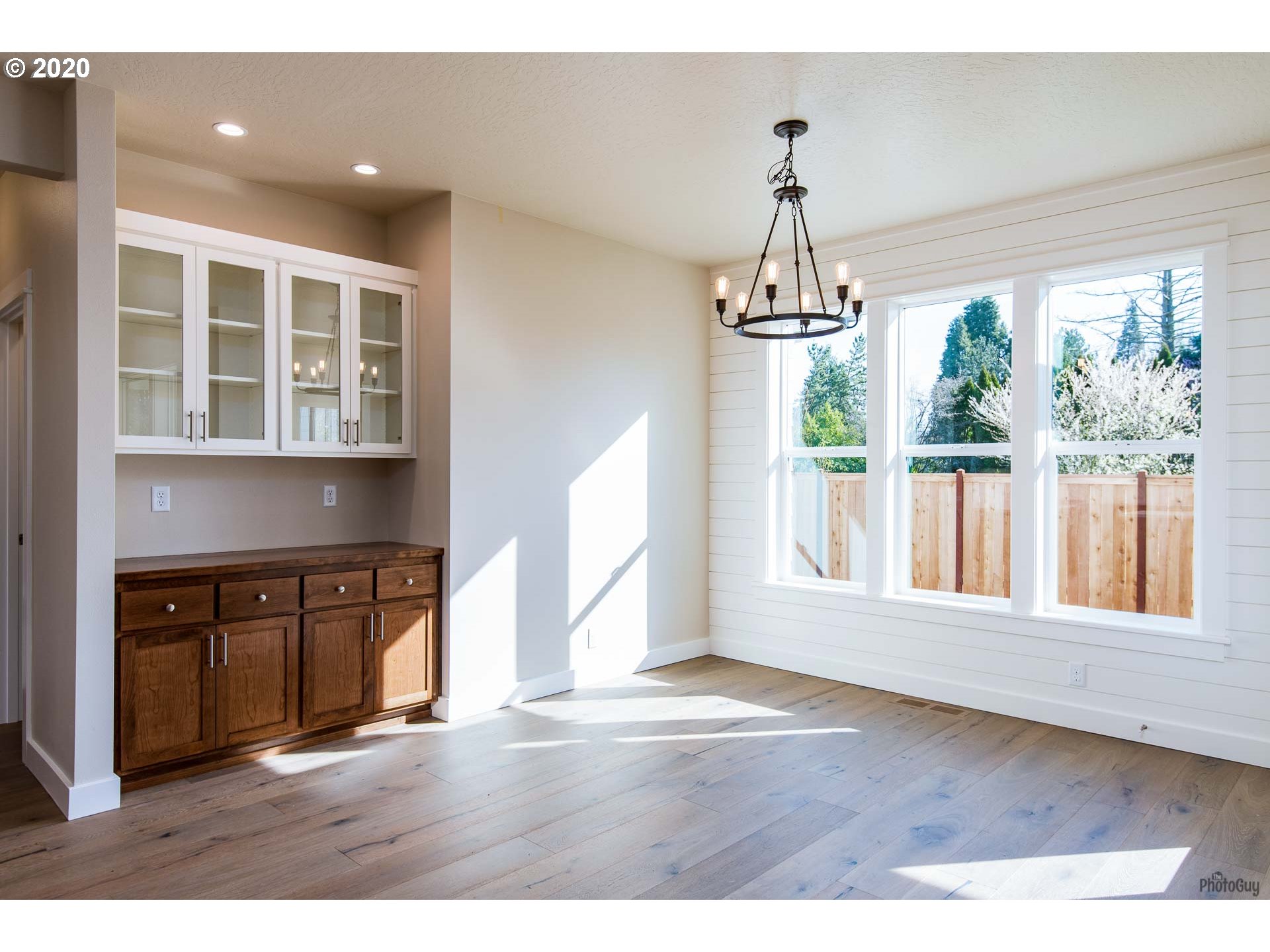 1017 South 33rd Street Springfield, OR 97478 - Photo 13 of 32 a view of an empty room with wooden floor and windows