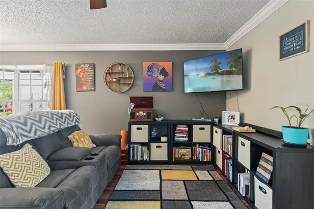 a living room with furniture and a book shelf