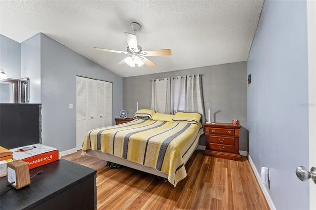 a bedroom with a bed and wooden floor