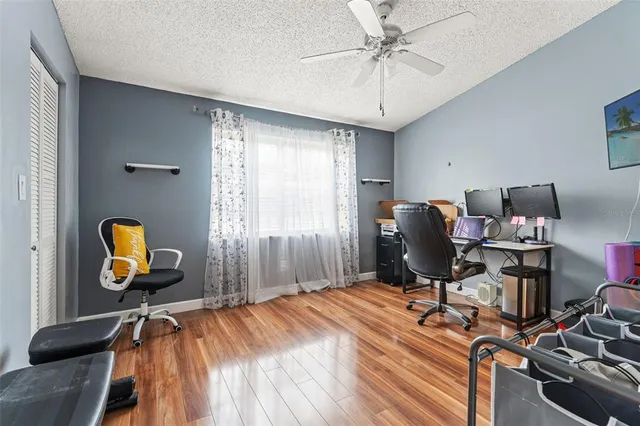 a view of a workspace with furniture and a window