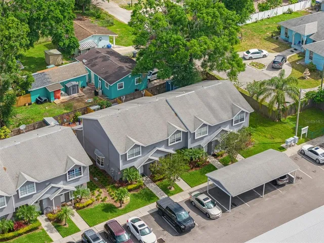 an aerial view of a house with garden space and street view