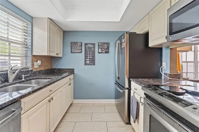 a kitchen with stainless steel appliances granite countertop a stove and a refrigerator