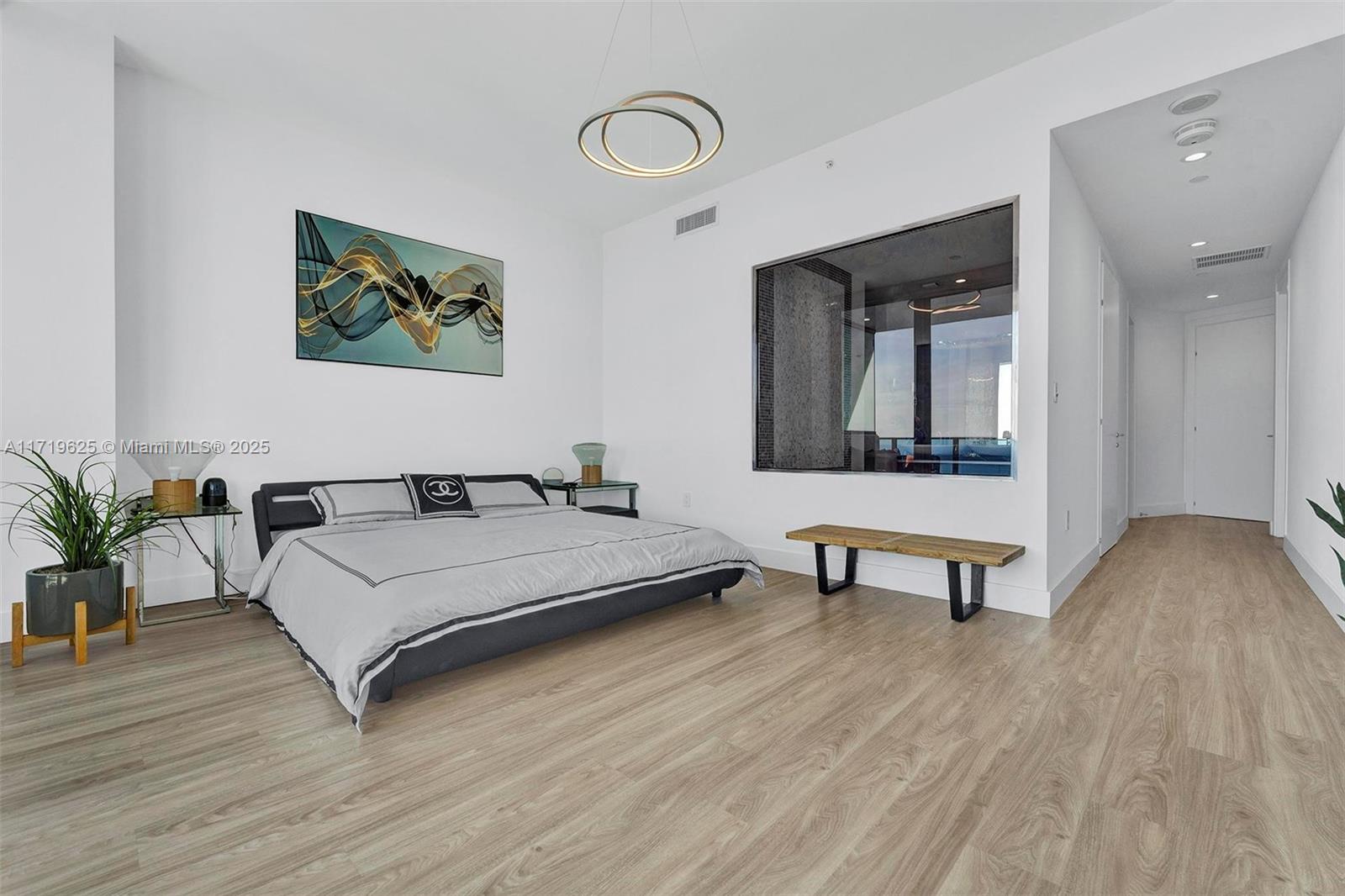 200 Biscayne Blvd Way, Unit 5001 Miami, FL 33131 - Photo 15 of 48 a bedroom with a bed and a table