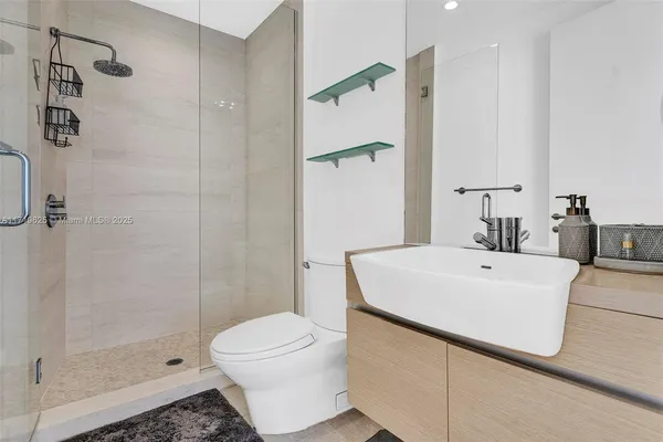 a bathroom with a toilet a sink and mirror