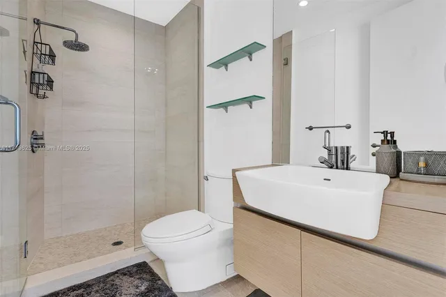 a bathroom with a toilet a sink and mirror