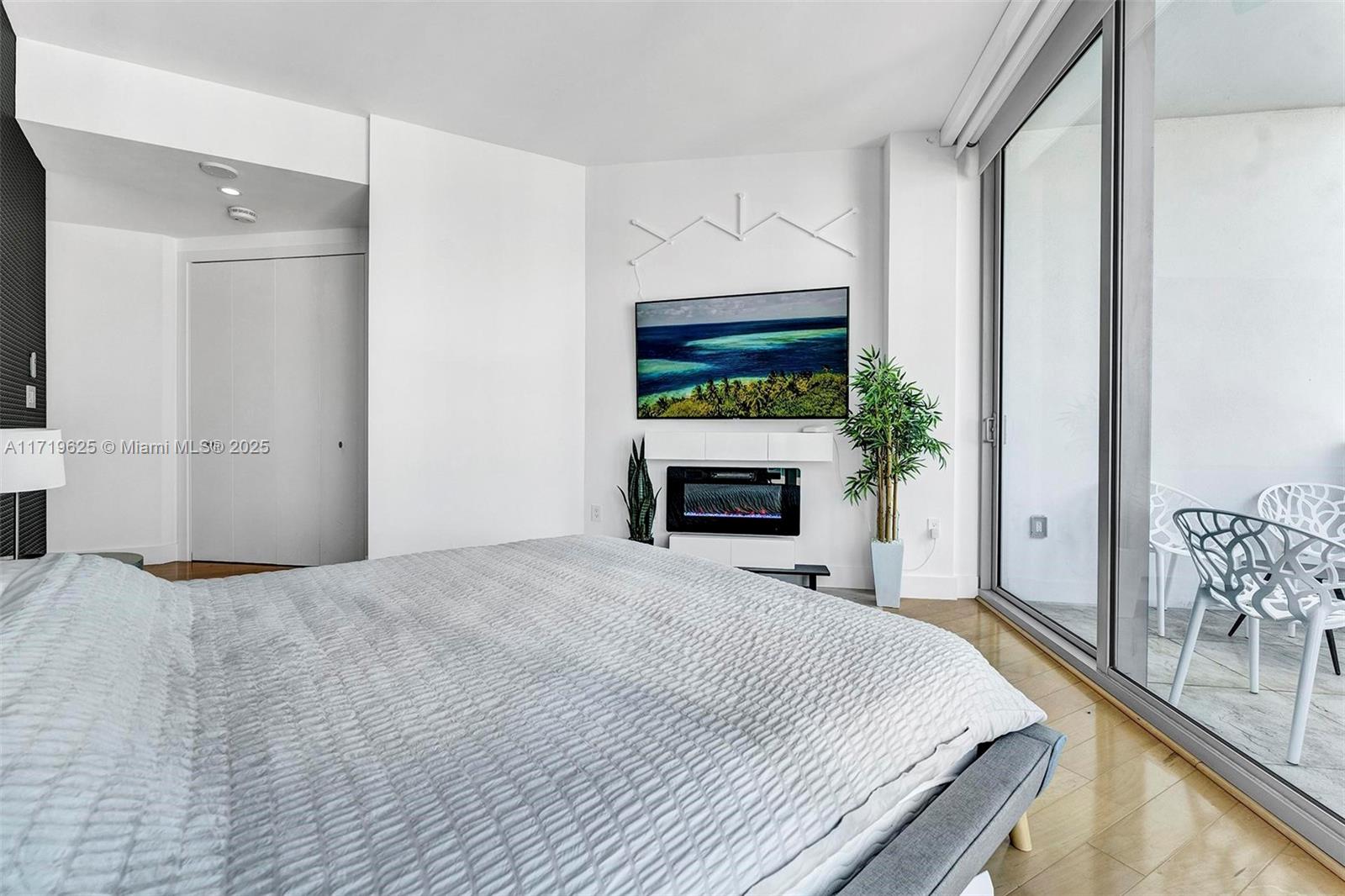 200 Biscayne Blvd Way, Unit 5001 Miami, FL 33131 - Photo 19 of 48 a bedroom with a bed and a fireplace