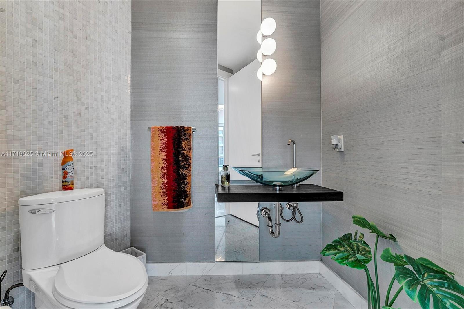 200 Biscayne Blvd Way, Unit 5001 Miami, FL 33131 - Photo 27 of 48 a bathroom with a sink a toilet and potted plant