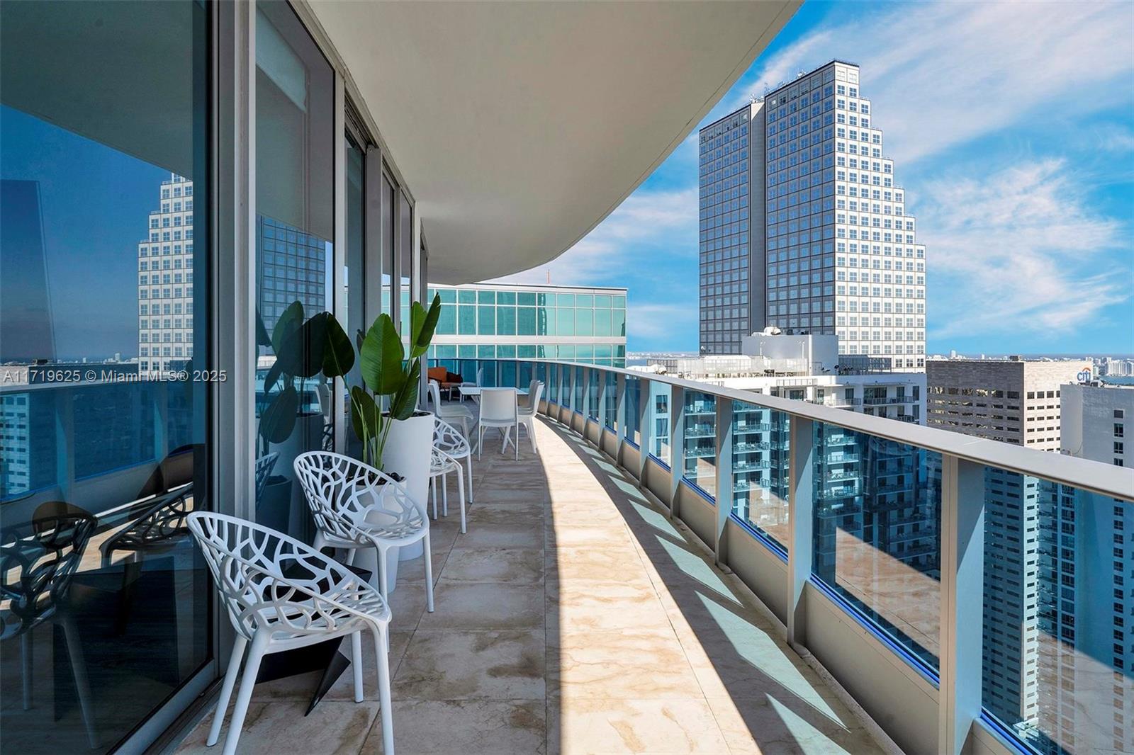 200 Biscayne Blvd Way, Unit 5001 Miami, FL 33131 - Photo 30 of 48 a balcony with furniture and wooden floor