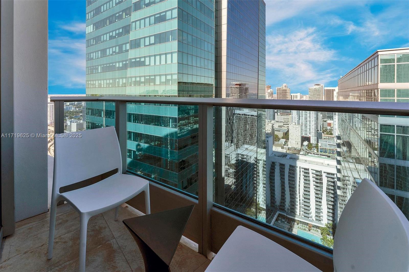 200 Biscayne Blvd Way, Unit 5001 Miami, FL 33131 - Photo 33 of 48 a view of a chairs and table in the balcony