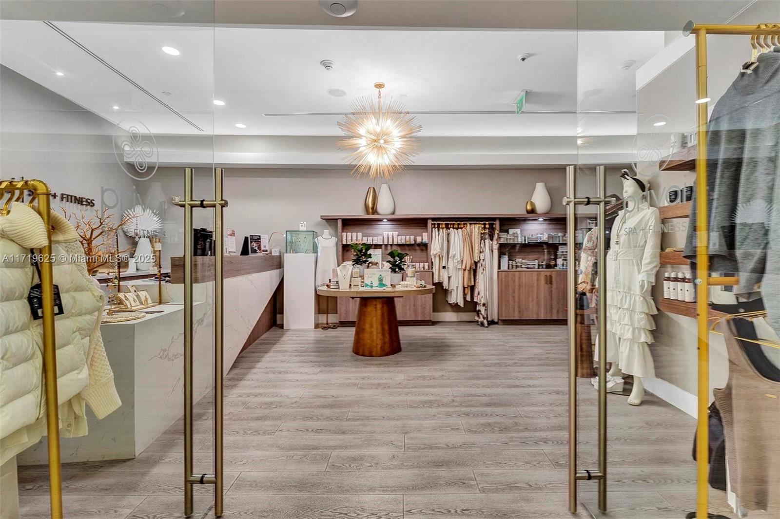 200 Biscayne Blvd Way, Unit 5001 Miami, FL 33131 - Photo 41 of 48 a kitchen with stainless steel appliances kitchen island granite countertop a table chairs in it and wooden floors