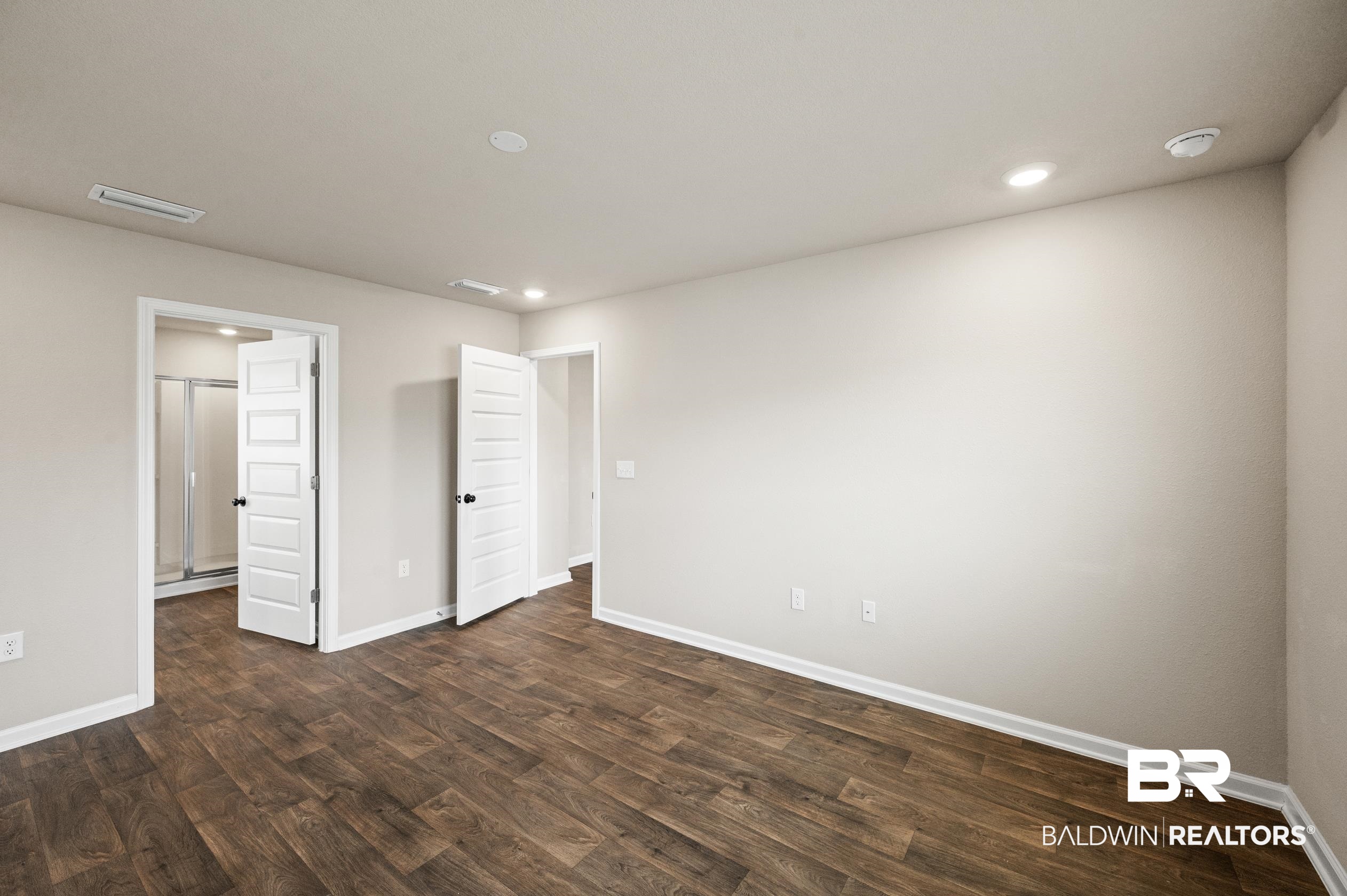 10353 Zenyatta Loop Daphne, AL 36526 - Photo 15 of 33 Unfurnished bedroom with dark wood-type flooring