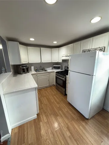 a kitchen with a refrigerator a sink and dishwasher