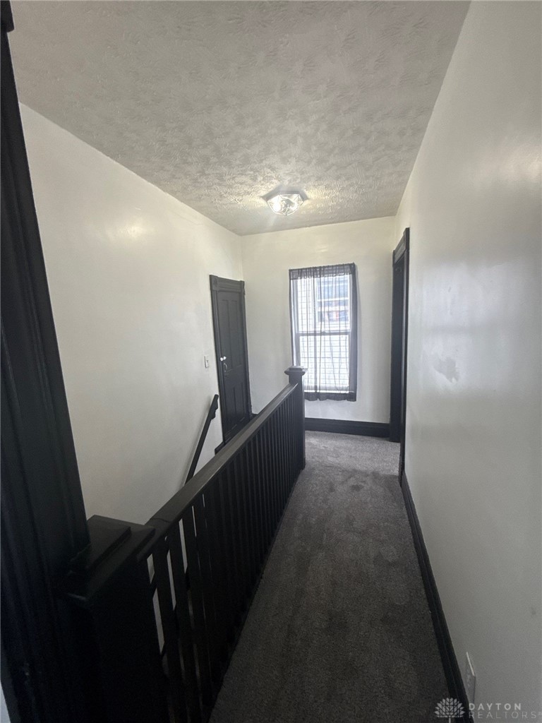 1125 West High Street Springfield, OH 45506 - Photo 23 of 39 This spacious hallway features plush carpeting and abundant natural light.