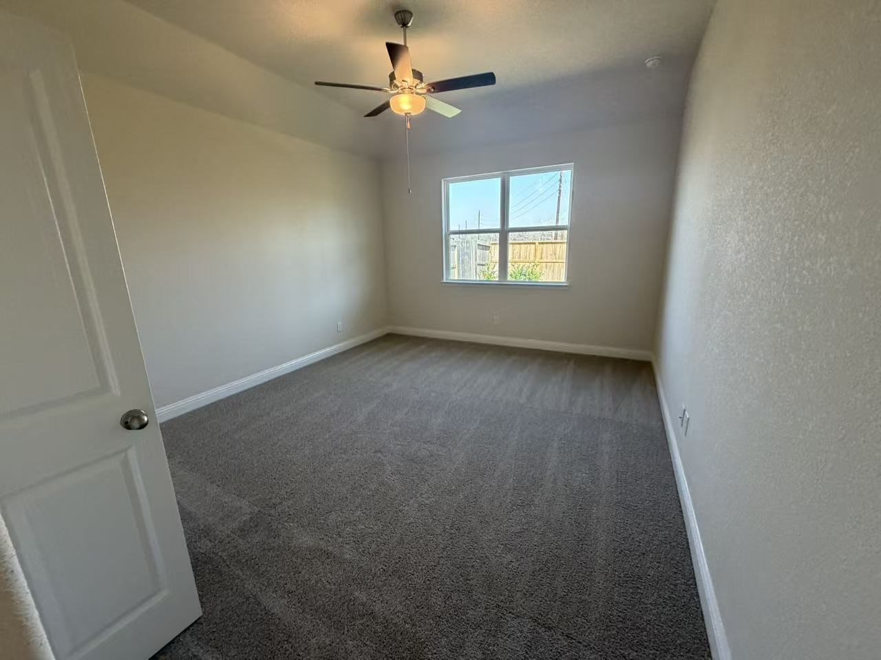 4014 Colony Lane Missouri City, TX 77459 - Photo 11 of 40 an empty room with windows and fan
