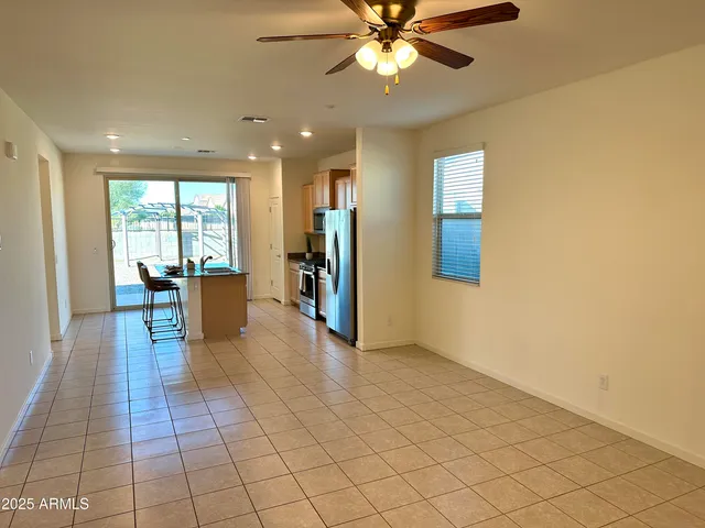 a view of a livingroom with wooden floor and furniture