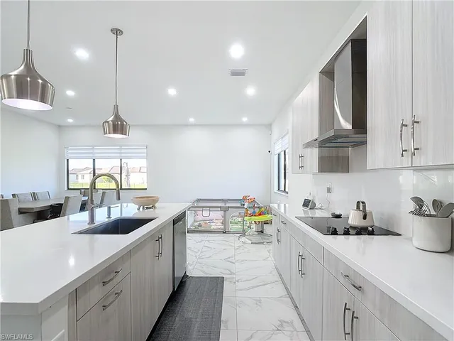a kitchen with stainless steel appliances a sink stove and cabinets