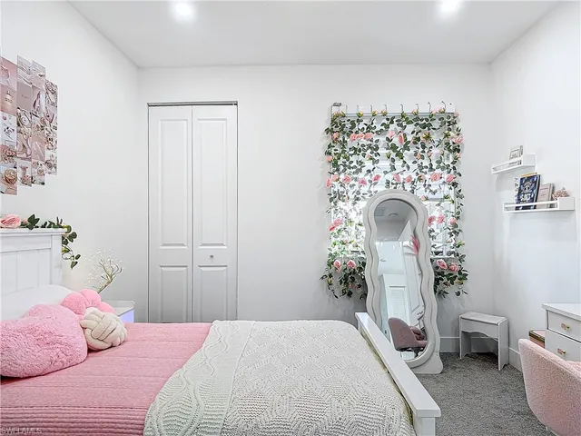 a bedroom with a bed and a chair
