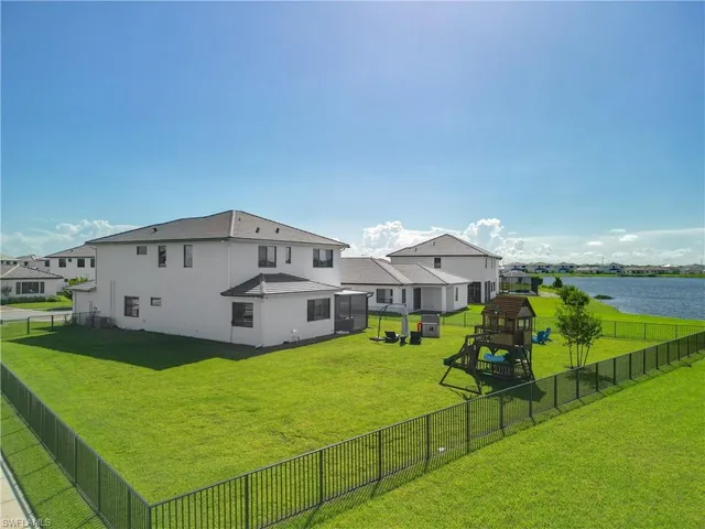a view of a house with a yard and sitting area