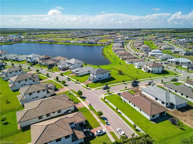 an aerial view of a house with a garden and lake view