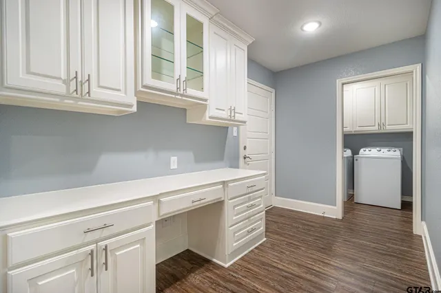 a kitchen with stainless steel appliances white cabinets and a window