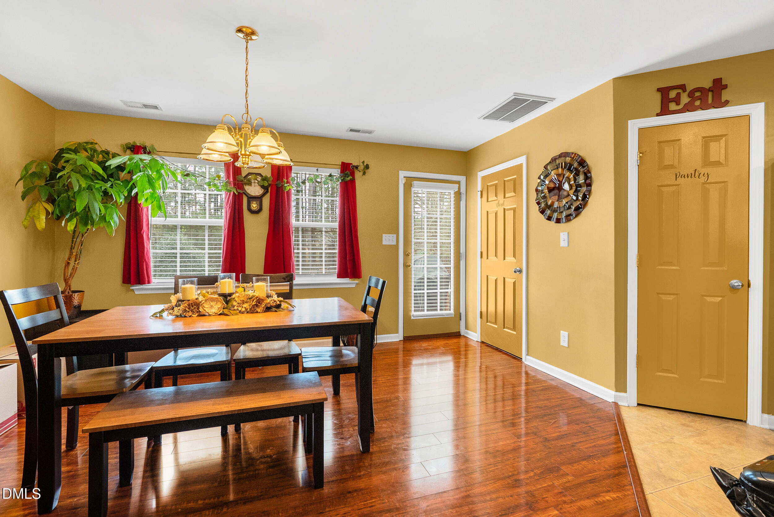 8840 Thornton Town Place Raleigh, NC 27616 - Photo 7 of 24 a view of a dining room with furniture window and wooden floor