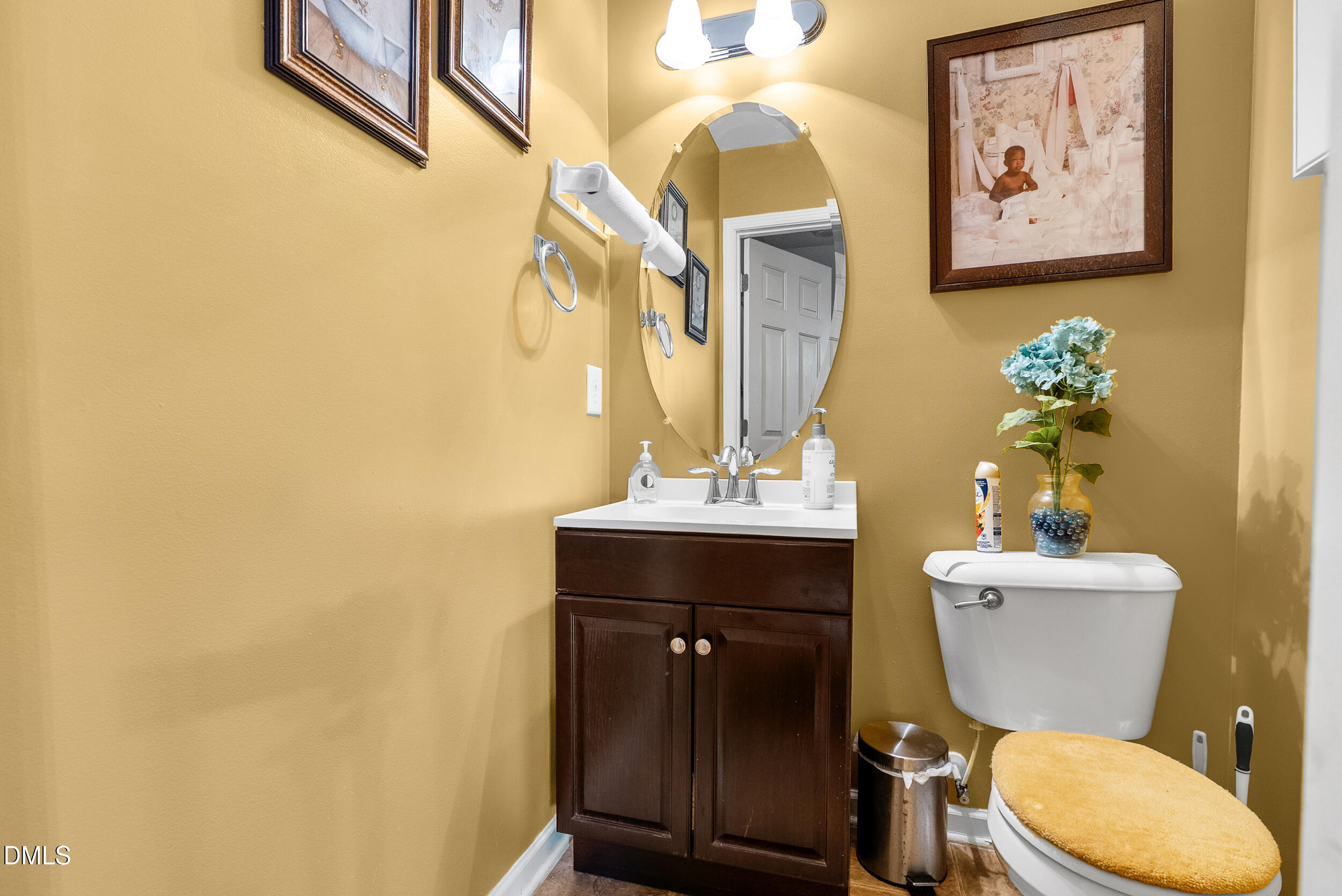 8840 Thornton Town Place Raleigh, NC 27616 - Photo 9 of 24 a bathroom with a toilet a sink and mirror
