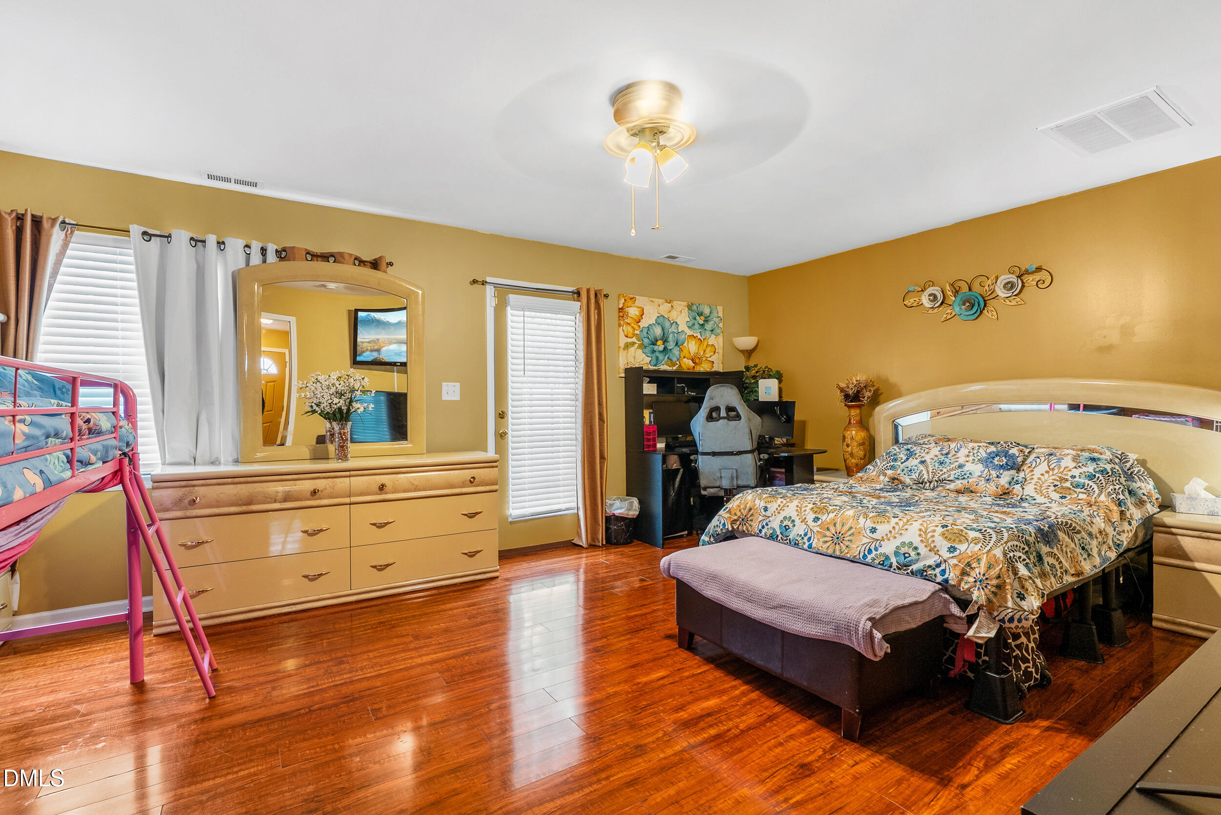 8840 Thornton Town Place Raleigh, NC 27616 - Photo 10 of 24 a bedroom with a bed and wooden floor