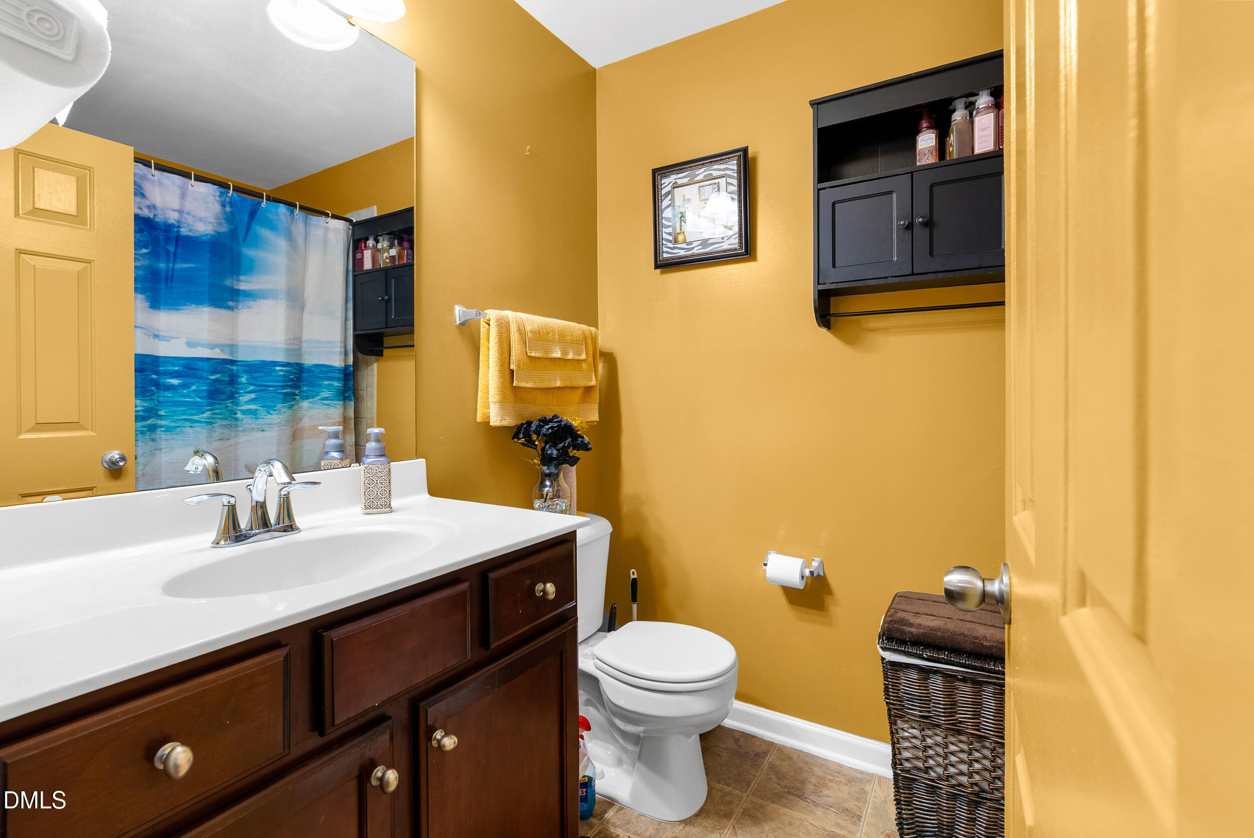 8840 Thornton Town Place Raleigh, NC 27616 - Photo 15 of 24 a bathroom with a sink mirror vanity and toilet