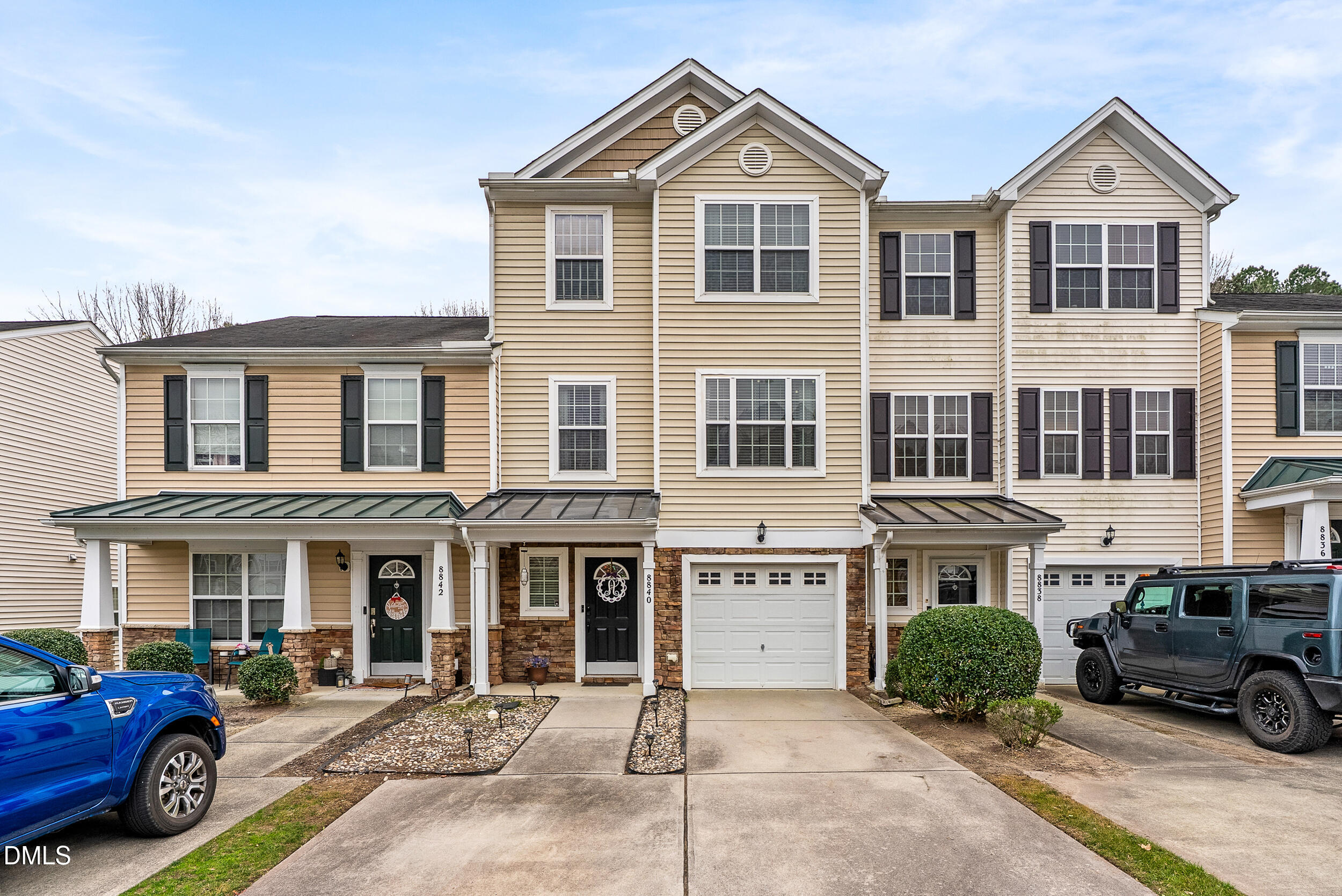8840 Thornton Town Place Raleigh, NC 27616 - Photo 19 of 24 a front view of a residential apartment building with a yard