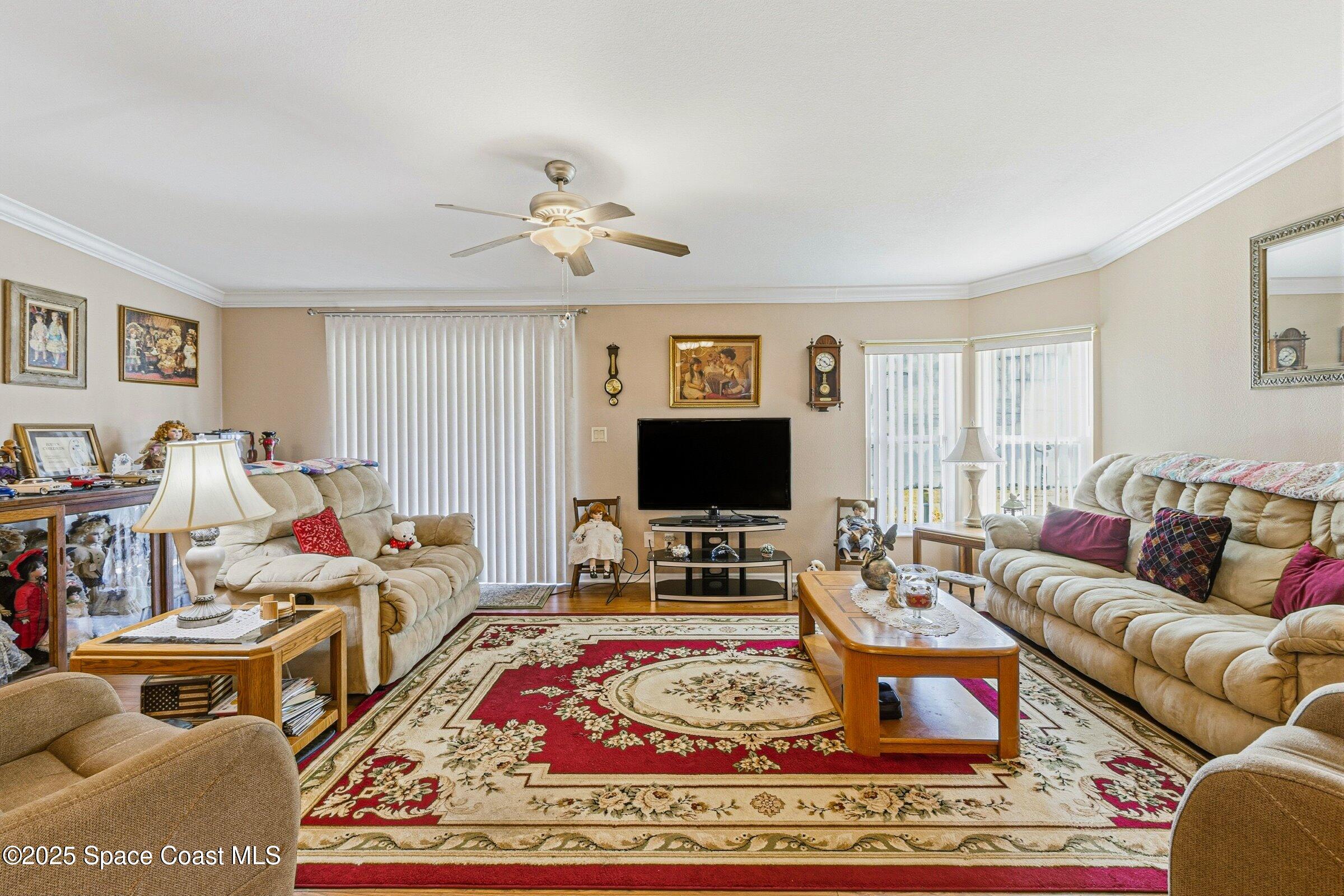 595 Outer Drive, Unit 129 Cocoa, FL 32926 - Photo 12 of 49 a living room with furniture and a flat screen tv